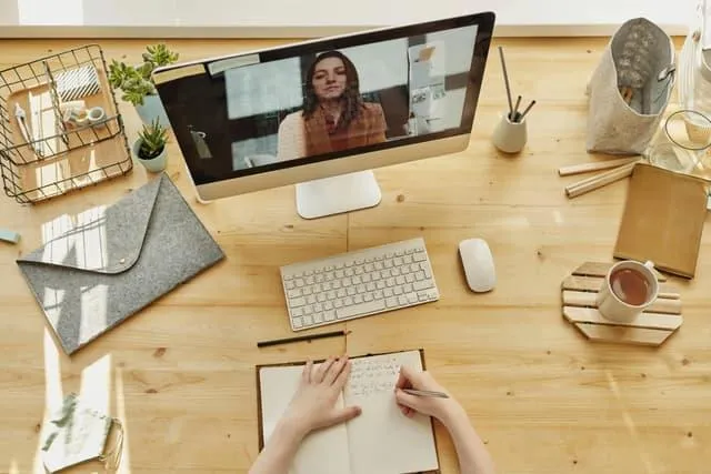 A provider taking notes of a patient during a virtual counseling session